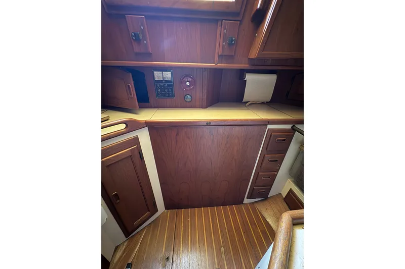 Slide: The Image of Interior of 1978 Pacific Seacraft 31 sailboat with wooden cabinetry and flooring. - 31