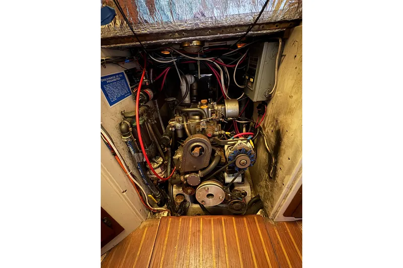 Slide: The Image of Engine compartment of a 1978 Pacific Seacraft 31 sailboat, showing detailed mechanical components. - 32
