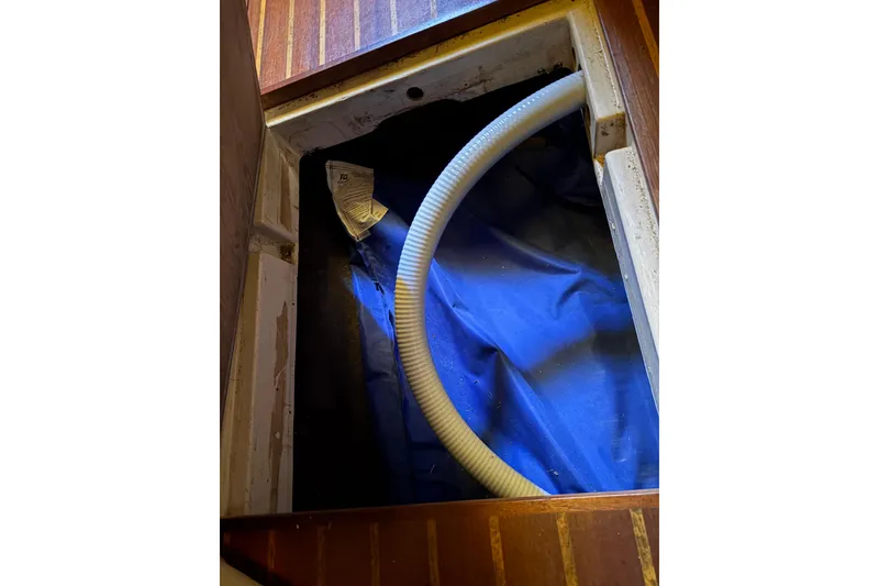 Slide: The Image of Open hatch with hose inside a 1978 Pacific Seacraft 31 sailboat. - 39