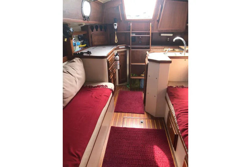 Slide: The Image of Interior of 1978 Pacific Seacraft 31 sailboat with cozy seating and wooden cabinetry. - 4