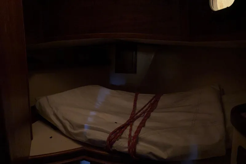 Slide: The Image of Cozy cabin interior of 1978 Pacific Seacraft 31 sailboat with bedding and porthole. - 40