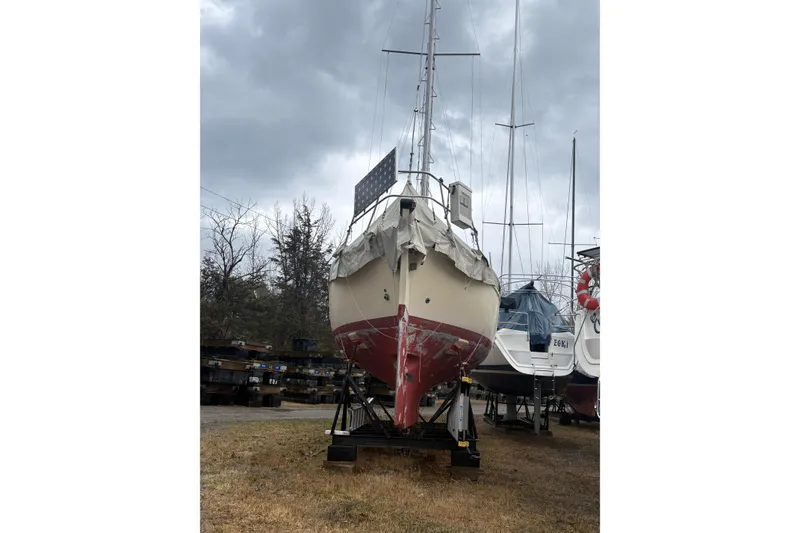 Slide: The Image of 1978 Pacific Seacraft 31 sailboat on dry dock under cloudy skies. - 8