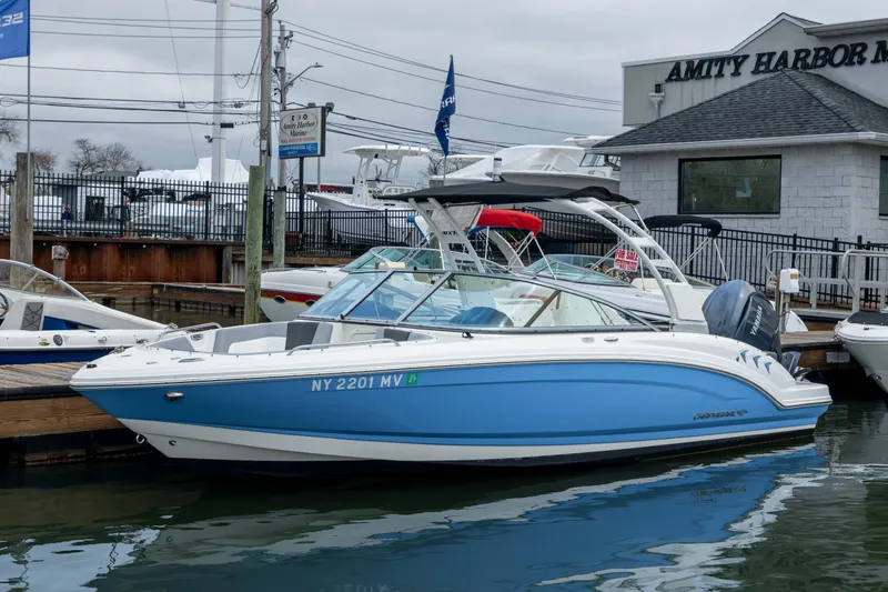 The Image of 2024 Chaparral 23 SSi OB boat docked at Amity Harbor Marine, blue and white design. - 1