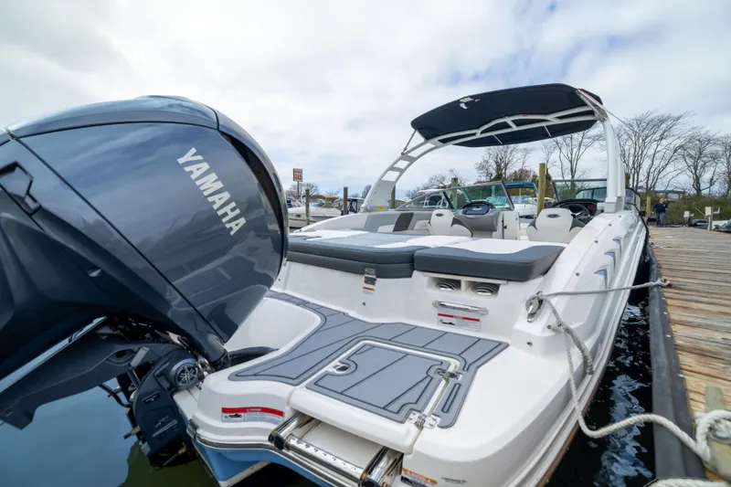 Slide: The Image of 2024 Chaparral 23 SSi OB boat with Yamaha outboard engine docked at marina. - 11