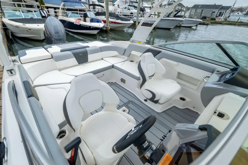 Slide: The Image of 2024 Chaparral 23 SSi OB boat interior with sleek white seating and modern design. - 13