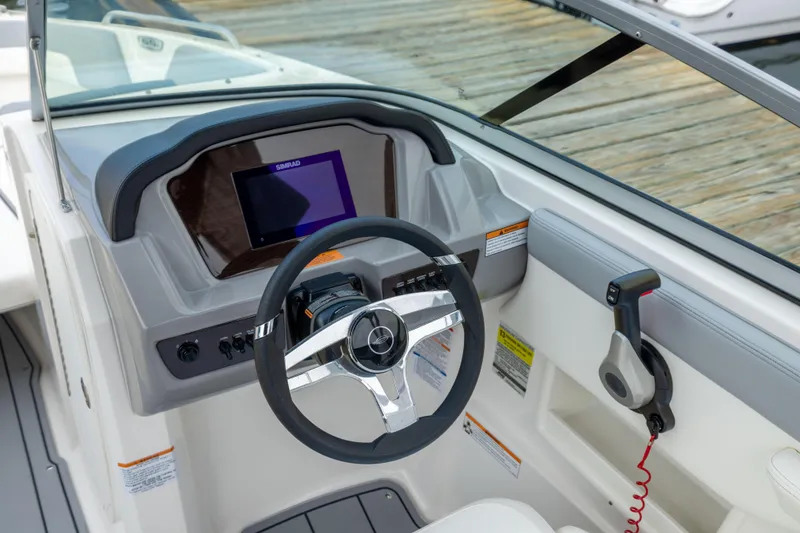 Slide: The Image of 2024 Chaparral 23 SSi OB boat dashboard with steering wheel and Simrad display. - 16