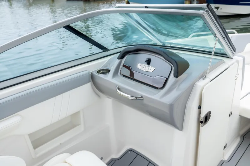 Slide: The Image of 2024 Chaparral 23 SSi OB boat interior with sleek dashboard and modern design. - 17
