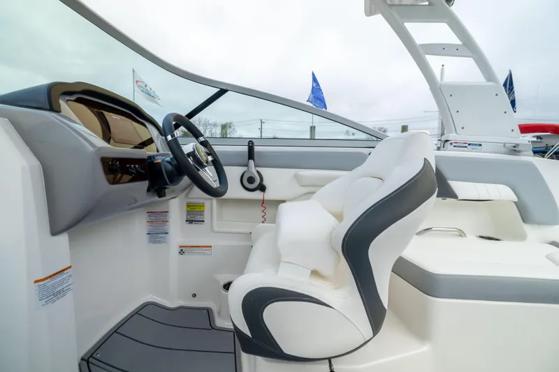 Slide: The Image of 2024 Chaparral 23 SSi OB boat interior with sleek steering and comfortable seating. - 18
