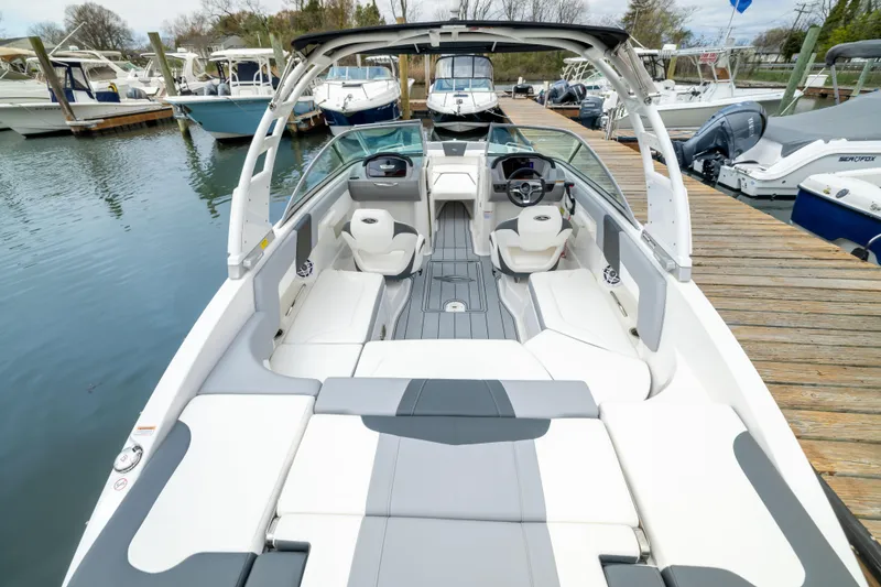 Slide: The Image of 2024 Chaparral 23 SSi OB boat interior at a marina dock. - 19