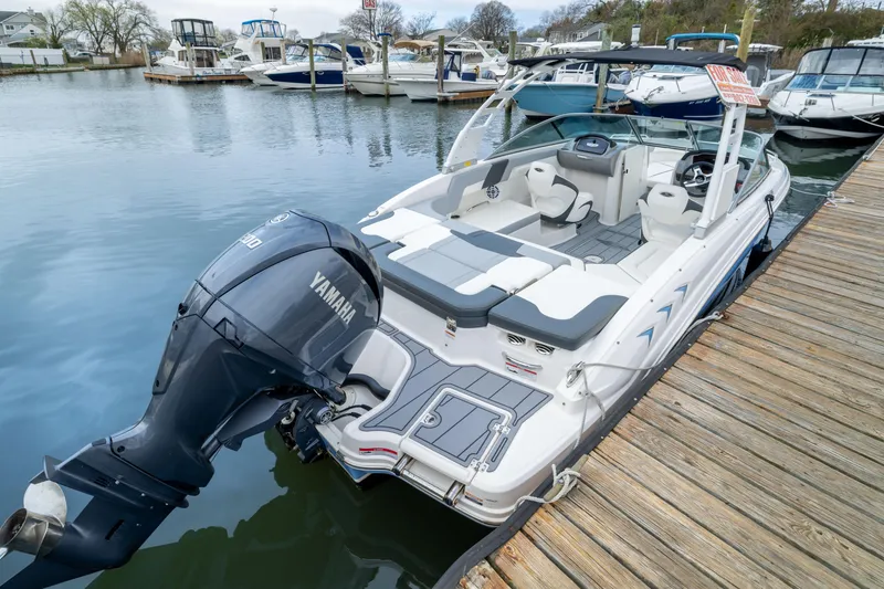 Slide: The Image of 2024 Chaparral 23 SSi OB boat docked with Yamaha outboard motor. - 3