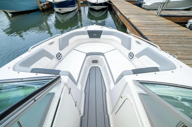 Slide: The Image of 2024 Chaparral 23 SSi OB boat interior with spacious seating at dock. - 4