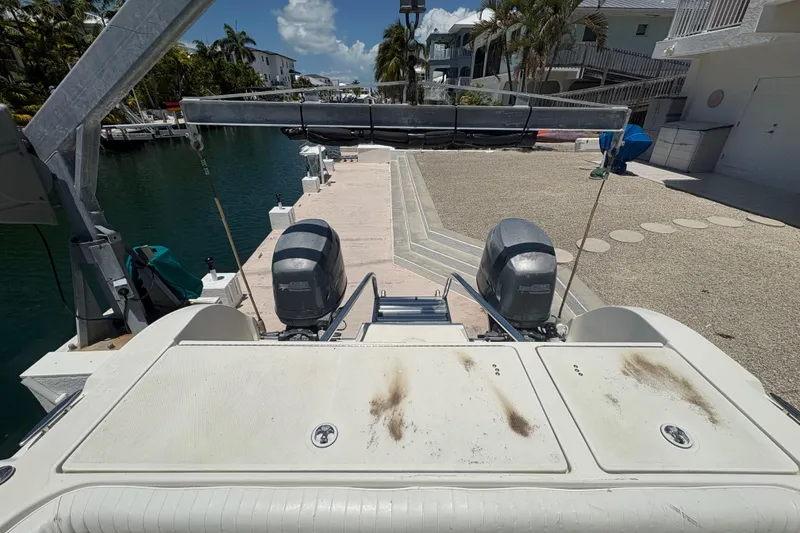Slide: The Image of Rear view of a 2002 World Cat 246 DC boat docked by a canal. - 12