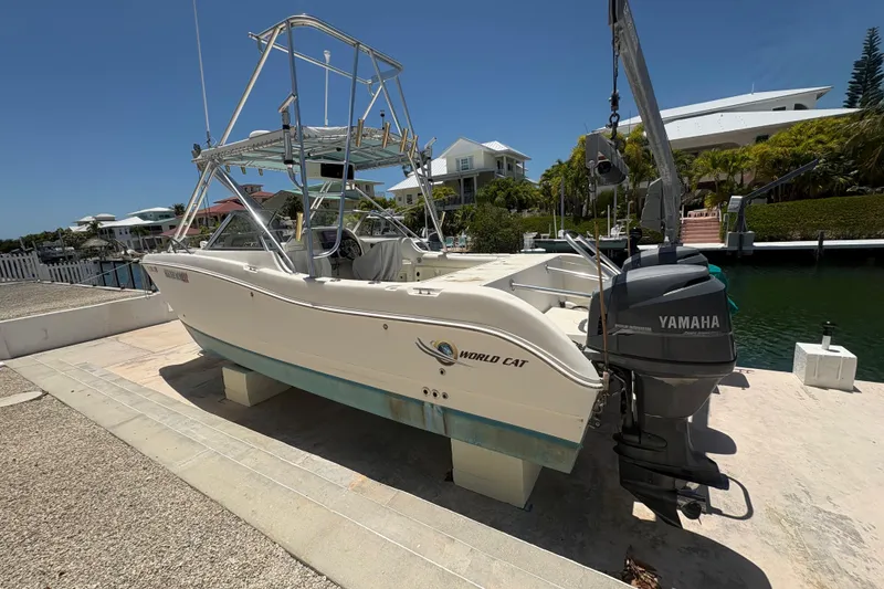 Slide: The Image of 2002 World Cat 246 DC boat with Yamaha engine docked near waterfront homes. - 4