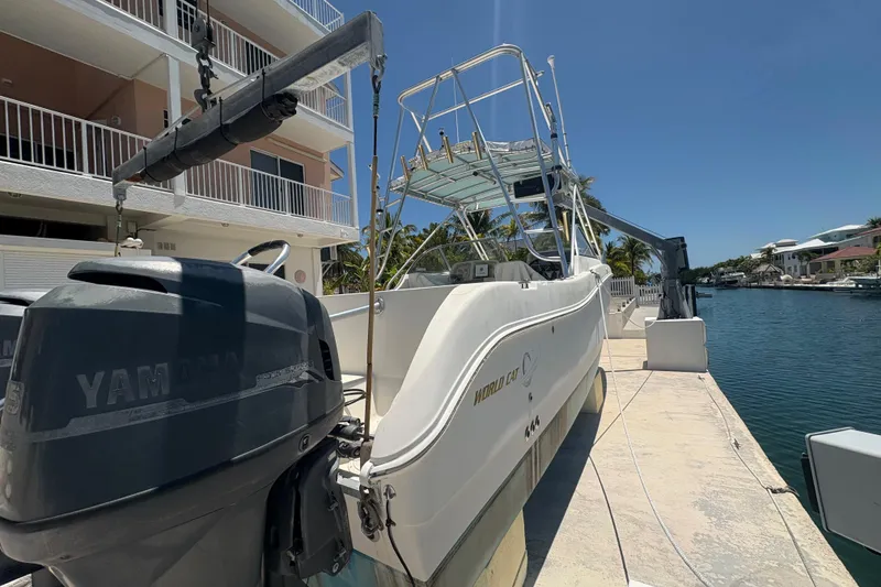 Slide: The Image of 2002 World Cat 246 DC boat docked with Yamaha outboard motor, sunny waterfront setting. - 6