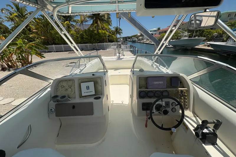Slide: The Image of Cockpit view of 2002 World Cat 246 DC boat with navigation equipment and steering wheel. - 8