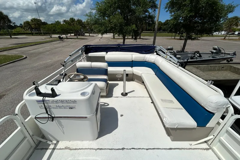 Slide: The Image of 2005 Bentley Pontoons 200 Fish interior with white and blue seating, steering console. - 5