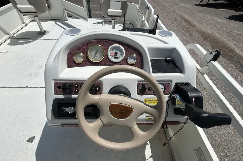 Slide: The Image of 2005 Bentley Pontoons 200 Fish dashboard with steering wheel and control panel. - 7