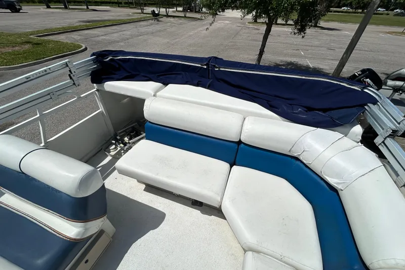 Slide: The Image of 2005 Bentley Pontoons 200 Fish interior with blue and white seating in a parking lot. - 8
