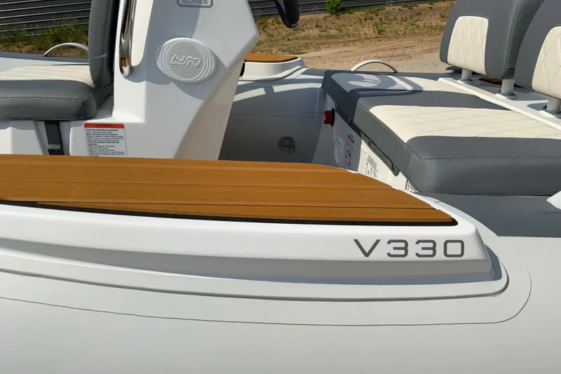 Slide: The Image of RIB boat interior with cushioned seating, labeled V330, featuring modern design elements. - 7