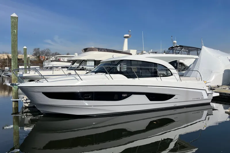 The Image of 2026 Beneteau Antares 11 Coupe yacht docked in marina under clear blue sky. - 0