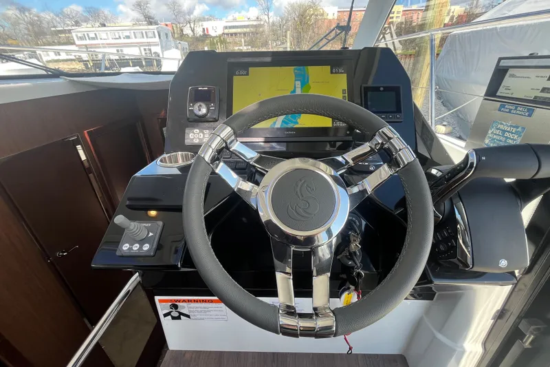 Slide: The Image of Helm of 2026 Beneteau Antares 11 Coupe with navigation display and controls. - 14
