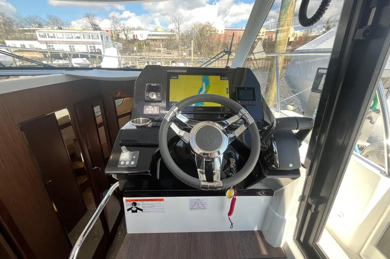 Slide: The Image of Helm of 2026 Beneteau Antares 11 Coupe with modern navigation system and sleek design. - 15