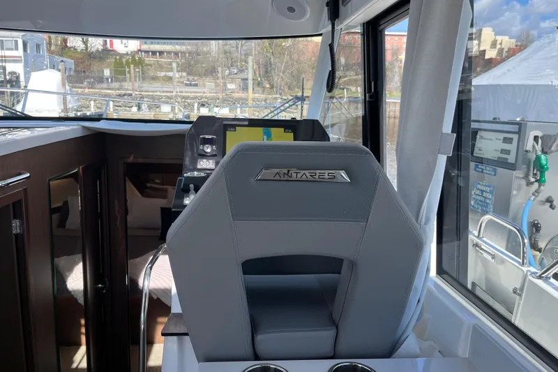 Slide: The Image of Interior of 2026 Beneteau Antares 11 Coupe, featuring helm seat and navigation equipment. - 16