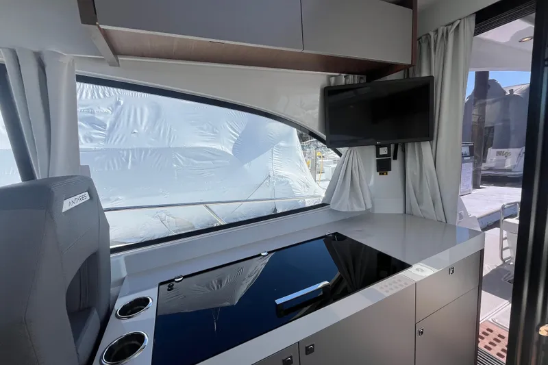Slide: The Image of Interior of 2026 Beneteau Antares 11 Coupe with modern kitchen and sleek design. - 18