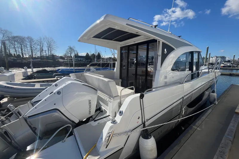 Slide: The Image of 2026 Beneteau Antares 11 Coupe docked, featuring sleek design and powerful Mercury outboard engines. - 2