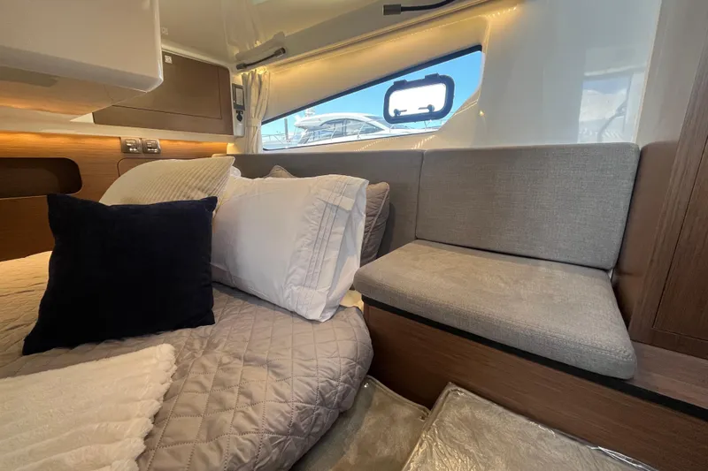 Slide: The Image of Interior of 2026 Beneteau Antares 11 Coupe, featuring cozy bedding and seating. - 21