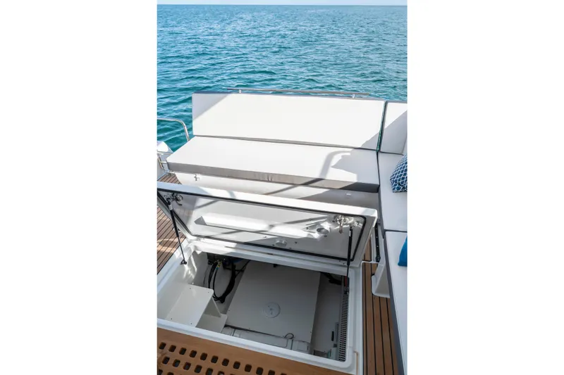Slide: The Image of 2026 Beneteau Antares 11 Coupe boat with open storage compartment on deck. - 9
