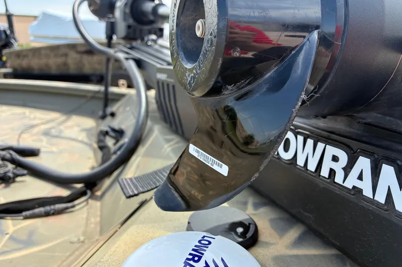 Slide: The Image of Close-up of a 2022 Tracker Grizzly 1860 CC boat's motor and Lowrance equipment. - 11