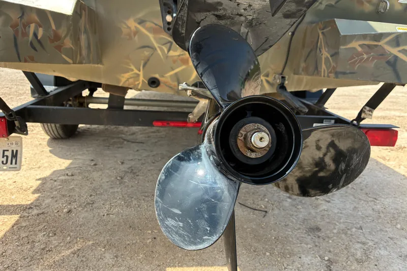 Slide: The Image of Propeller of 2022 Tracker Grizzly 1860 CC boat on trailer, close-up view. - 12