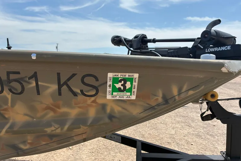 Slide: The Image of 2022 Tracker Grizzly 1860 CC boat with registration sticker and Lowrance equipment. - 4