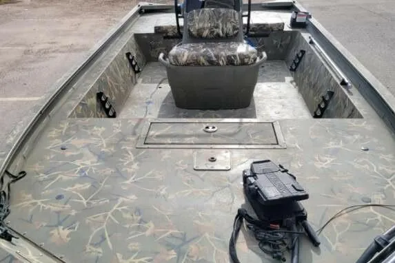Slide: The Image of 2022 Tracker Grizzly 1860 CC boat with camouflage design and central seating. - 8
