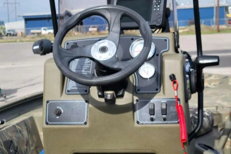 Slide: The Image of Steering console of 2022 Tracker Grizzly 1860 CC boat with gauges and controls. - 9