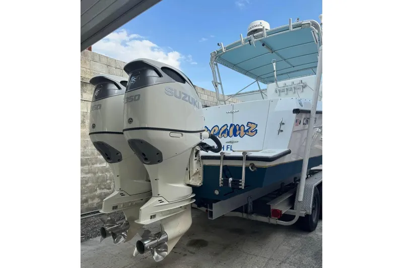 Slide: The Image of 1998 Contender 35 Express Side Console with twin Suzuki outboard motors. - 10