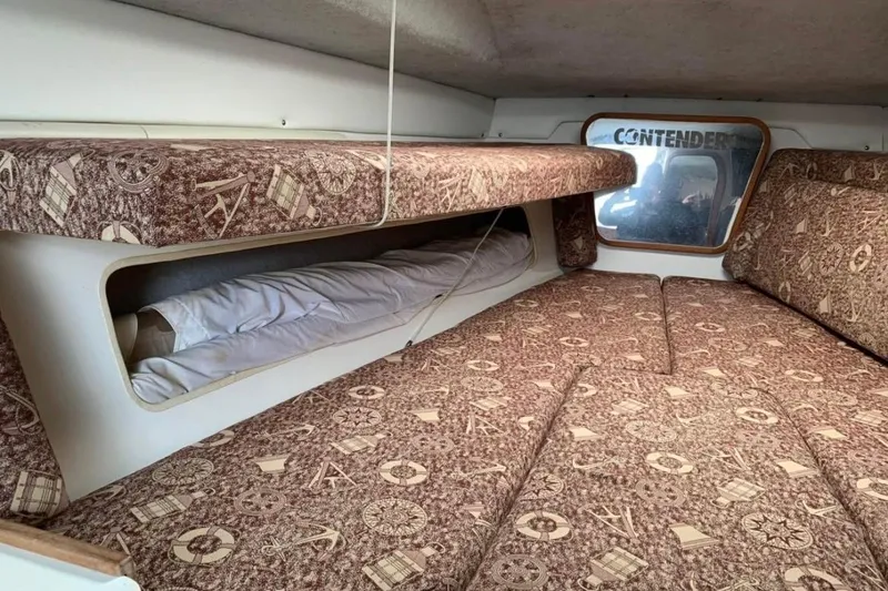 Slide: The Image of Interior cabin of 1998 Contender 35 Express Side Console boat with patterned upholstery. - 13