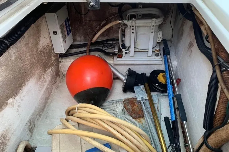 Slide: The Image of Storage compartment of a 1998 Contender 35 Express Side Console with marine equipment. - 16