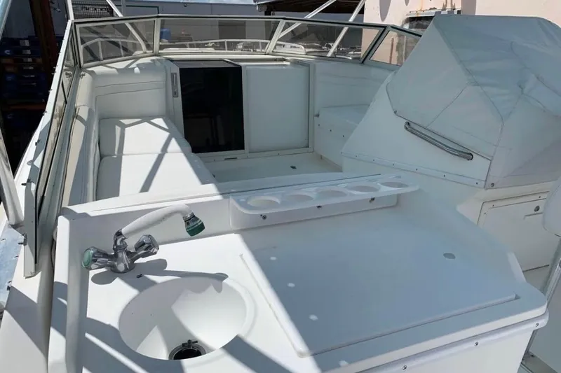 Slide: The Image of 1998 Contender 35 Express Side Console boat interior with sink and seating area. - 2