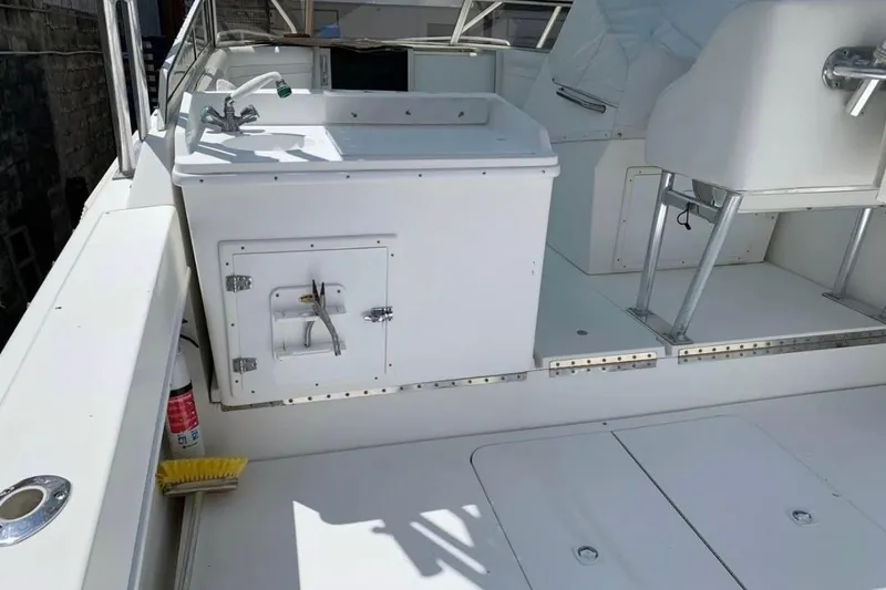 Slide: The Image of 1998 Contender 35 Express Side Console boat interior with sink and seating area. - 3
