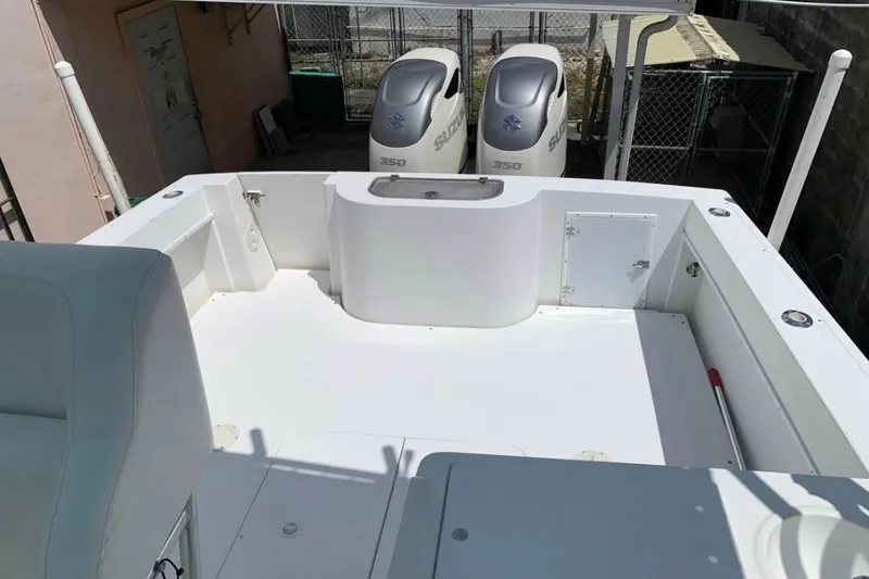 Slide: The Image of 1998 Contender 35 Express Side Console boat deck with dual Suzuki 350 engines. - 4