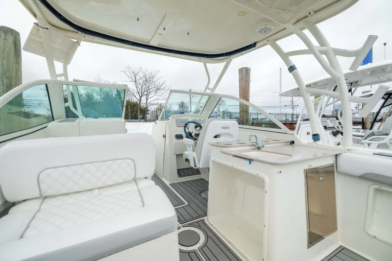 Slide: The Image of 2014 Sailfish 275 DC boat interior with seating and helm station. - 5