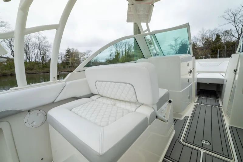 Slide: The Image of 2014 Sailfish 275 DC boat interior with white seating and sleek design. - 6