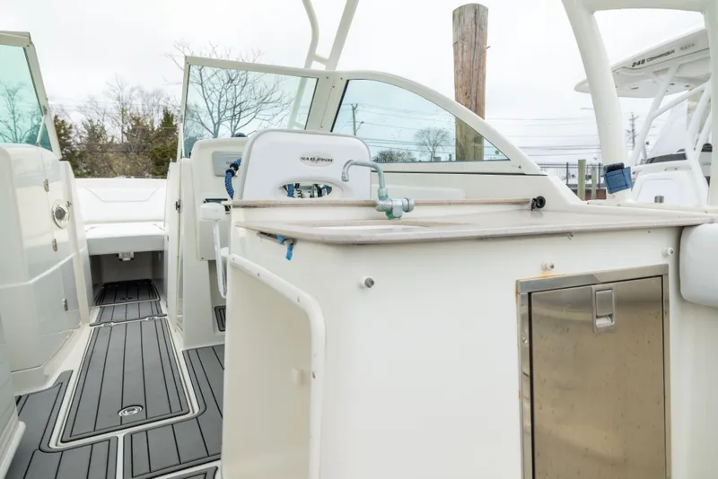 Slide: The Image of 2014 Sailfish 275 DC boat interior with seating and storage compartments. - 8