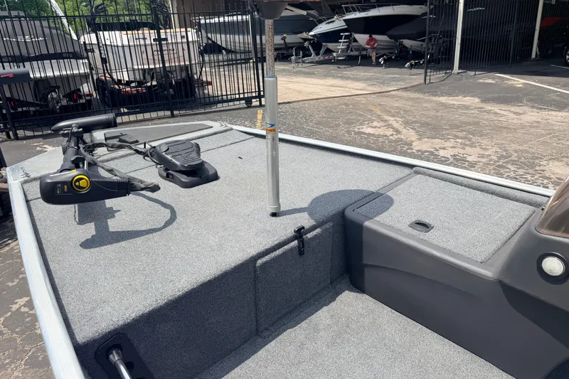 Slide: The Image of 2019 Bass Tracker III Classic boat deck with trolling motor in a marina setting. - 15