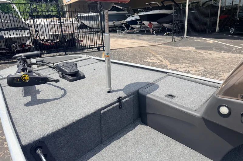 Slide: The Image of 2019 Bass Tracker III Classic boat interior with trolling motor and storage compartments. - 16