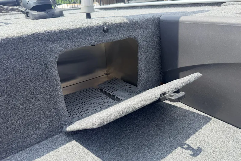 Slide: The Image of Bass Tracker III Classic 2019 boat storage compartment with open hatch, showcasing interior space. - 17