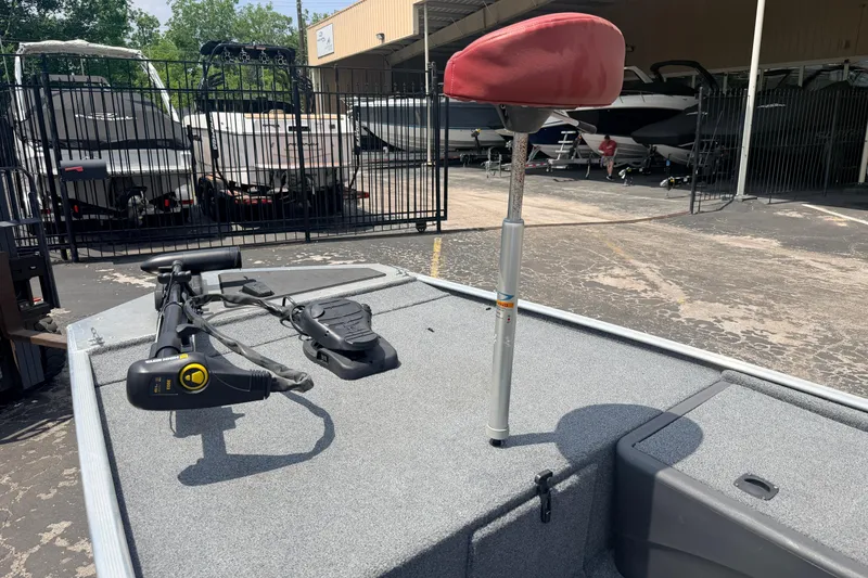 Slide: The Image of 2019 Bass Tracker III Classic boat with trolling motor and red seat in a marina. - 19