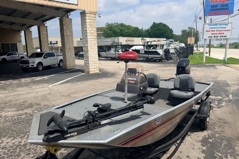 Slide: The Image of 2019 Bass Tracker III Classic fishing boat parked at dealership, featuring Minn Kota trolling motor. - 21